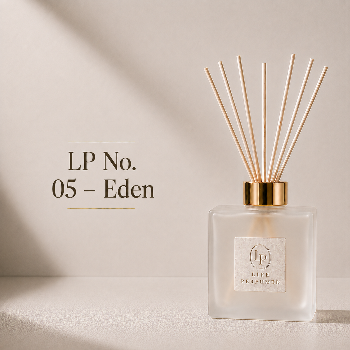 A reed diffuser bottle with a frosted glass body, gold collar, and natural reed sticks, shown on a warm beige surface with text reading 'LP No. 05 - Eden'. Crisp green apple, refreshing cucumber and delicate florals create a vibrant fragrance that's as fresh as a morning walk through an orchard. Bright, energetic and beautifully uplifting.