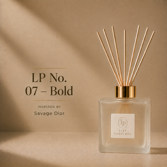 A reed diffuser bottle with a frosted glass body, gold cap, and light wood reeds, shown on a warm beige background with text reading 'LP No. 07 - Bold' and 'Inspired by Savage Dior.